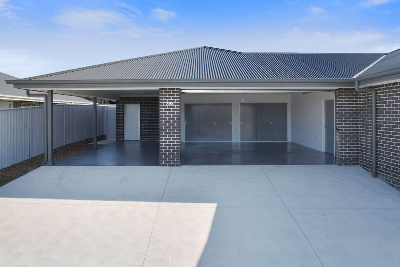 Carport and garage at 38A, with a covered path to the entry.